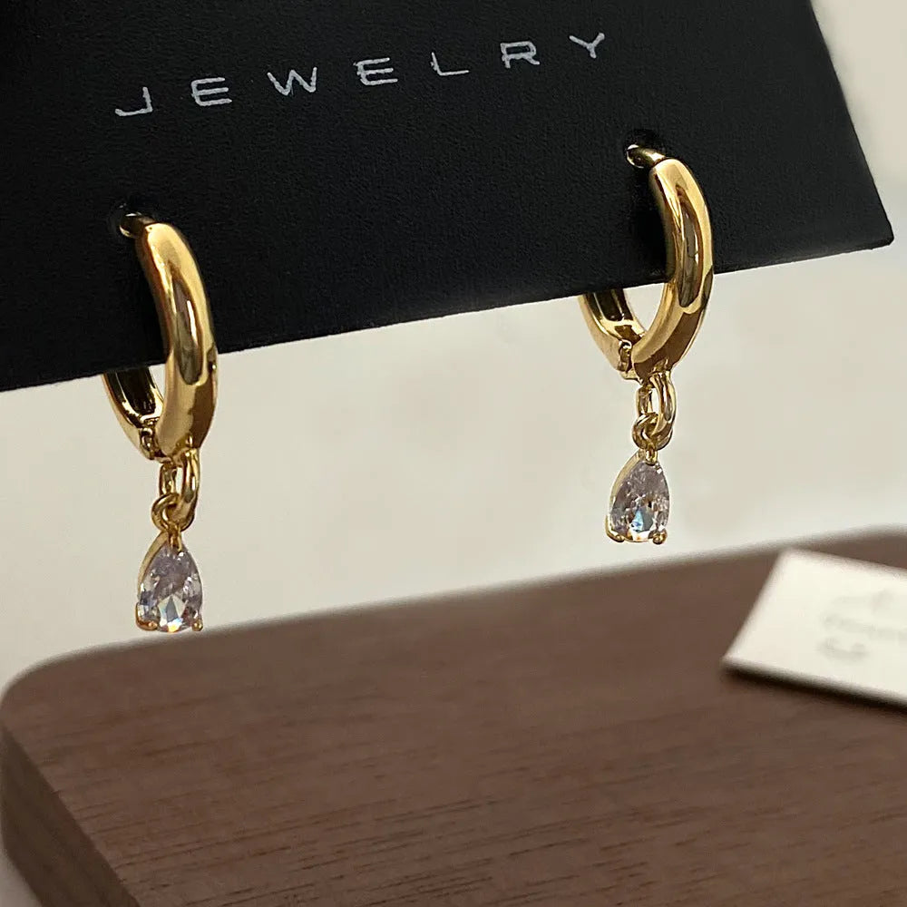 Zircon jewellery set with geometric pendant necklace, matching earrings, and anklet in silver-tone chain