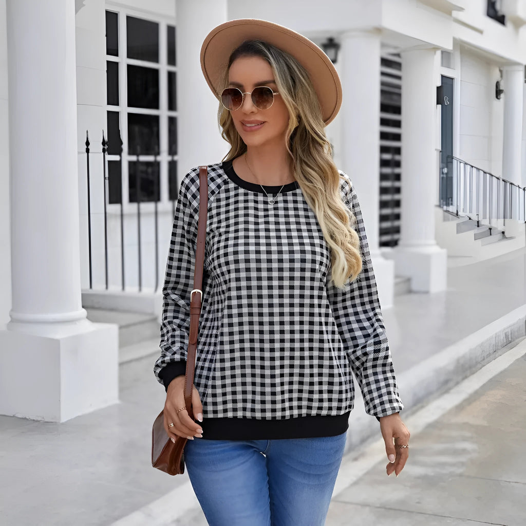 Black polyester pullover sweater with a plaid printed pattern and long sleeves.