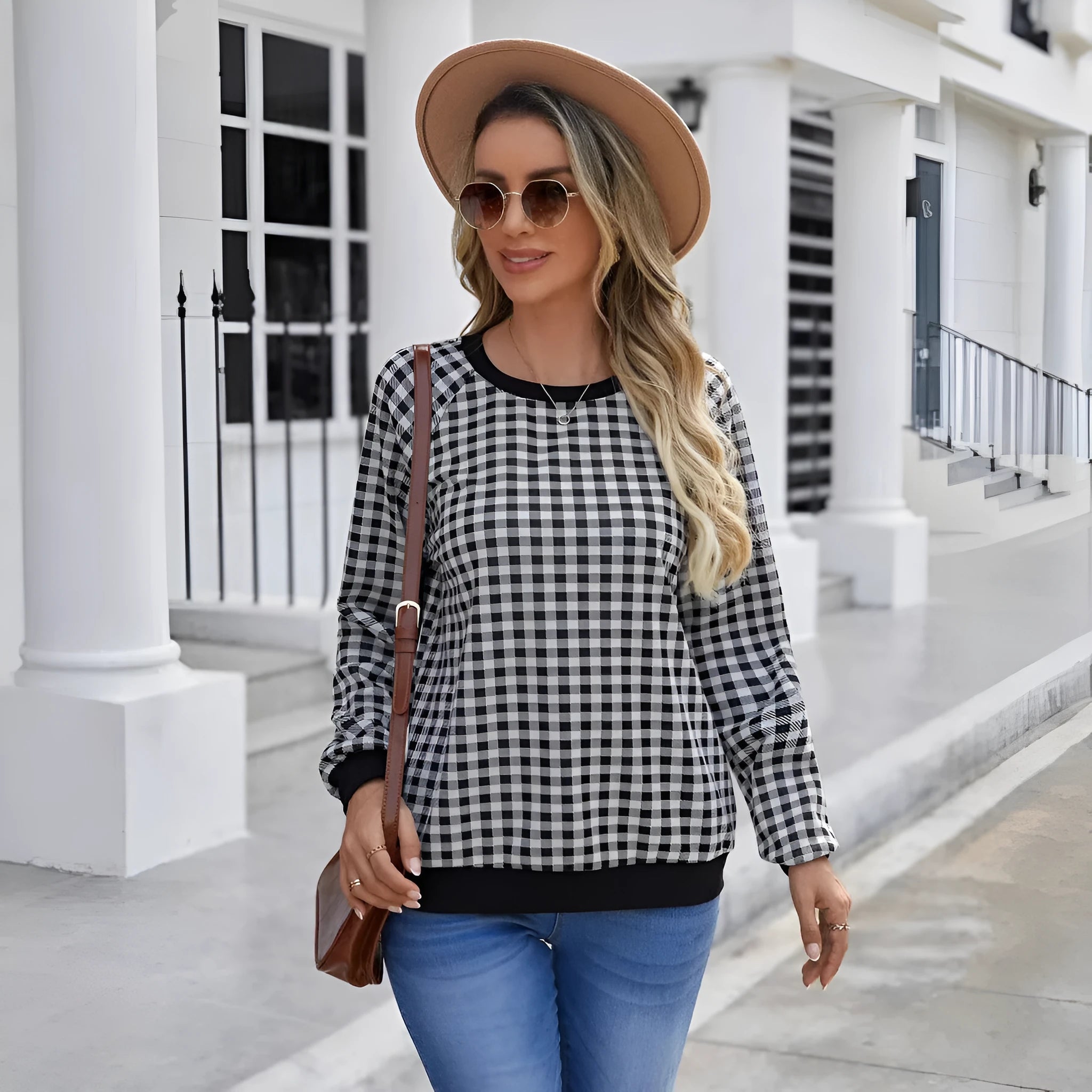 Black polyester pullover sweater with a plaid printed pattern and long sleeves.