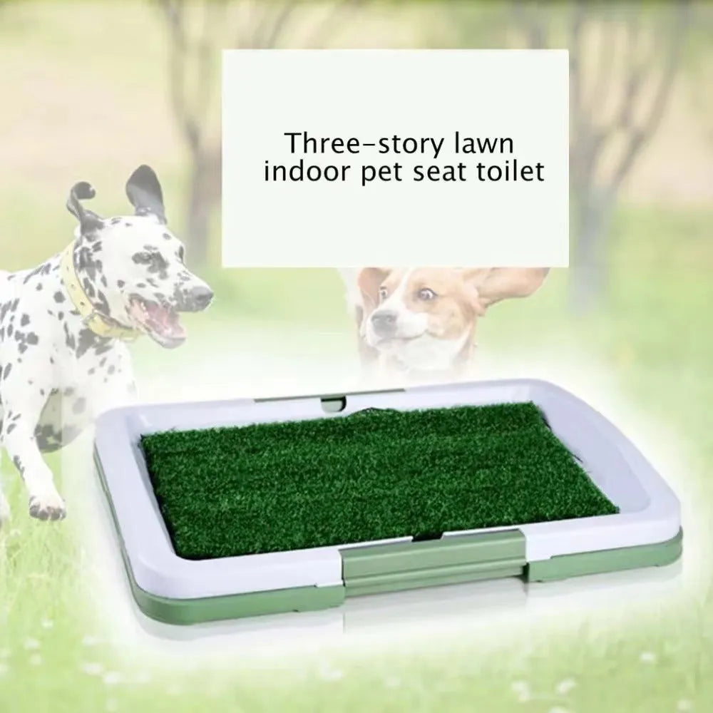 Green three-layer indoor dog toilet tray with artificial grass top, absorbent pad, and plastic drip tray base.