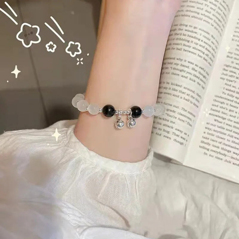 Chinese style handmade glass bead bracelet with bamboo joint elements on a white background.