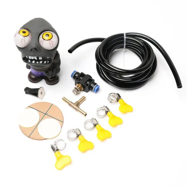 Turbo car blow-off valve ornament kit showing rubber doll, copper tube, pressure valve, and tubing on a car vent.