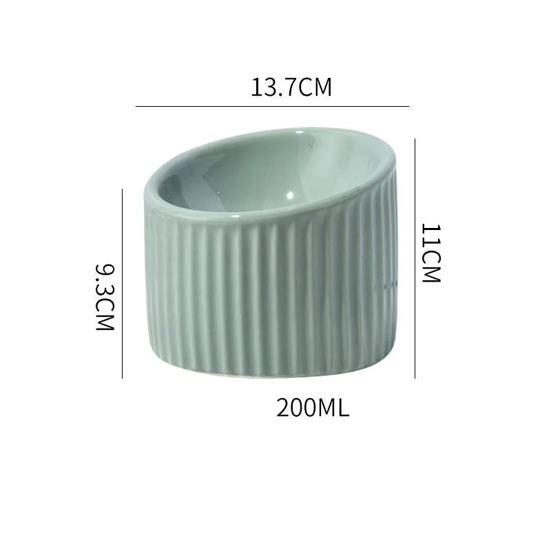 Ceramic elevated cat bowl in green colour, showing tilted design and raised feeding height.