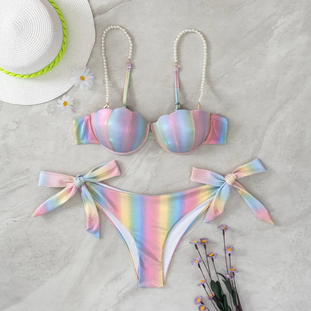 Women's shell rainbow print bikini swimsuit with split tied design on a beach background