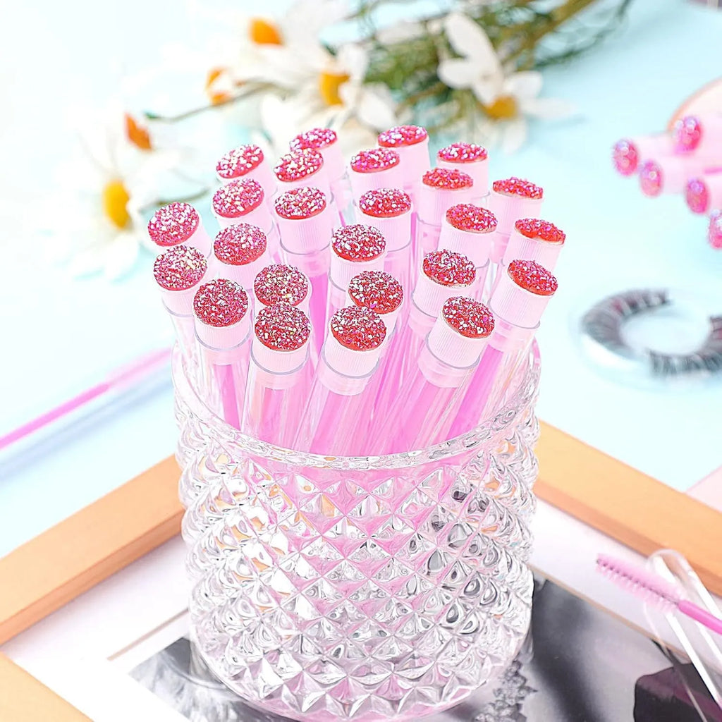 Disposable eyelash and mascara brushes in transparent plastic tubes with spiral brush heads