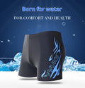 Men's plus size blue fire design boxer swimming trunks with matching swimming cap on a black background.