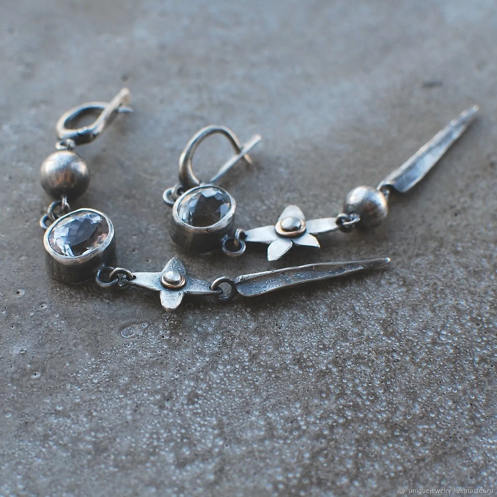 Geometric long pendant earrings in antique silver with rhinestone details on a stud.