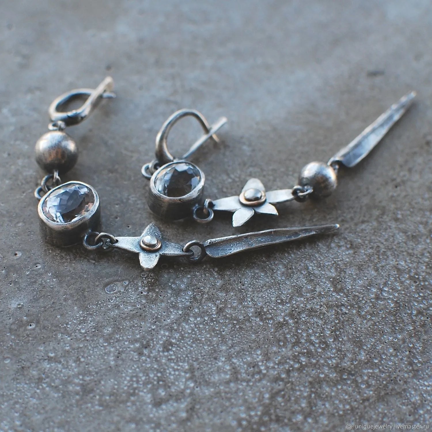 Geometric long pendant earrings in antique silver with rhinestone details on a stud.