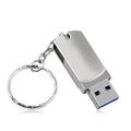White metal USB flash drive with rotating casing showing compact size
