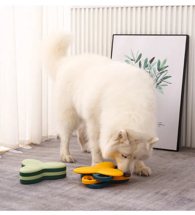 Green and yellow interactive dog puzzle toy with rotatable compartments and bone-shaped covers