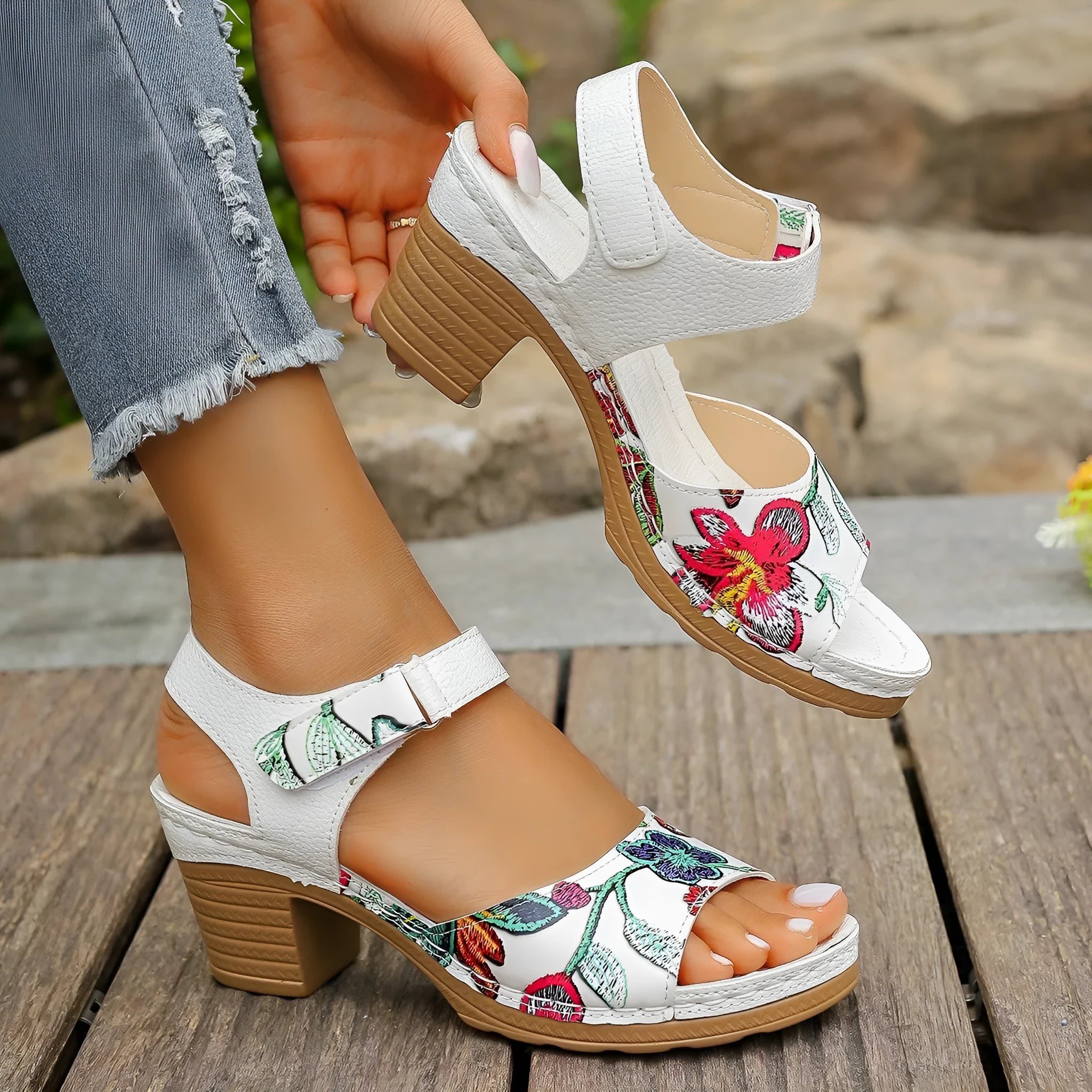 White women's high heel sandals with a Velcro strap fastener on a casual rubber sole.
