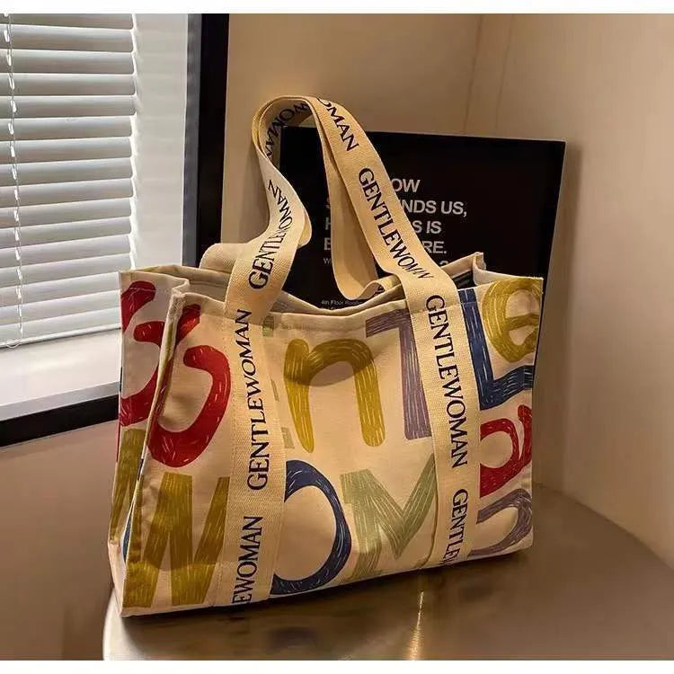 Large canvas tote bag with printed design, shown in available colour and pattern options.