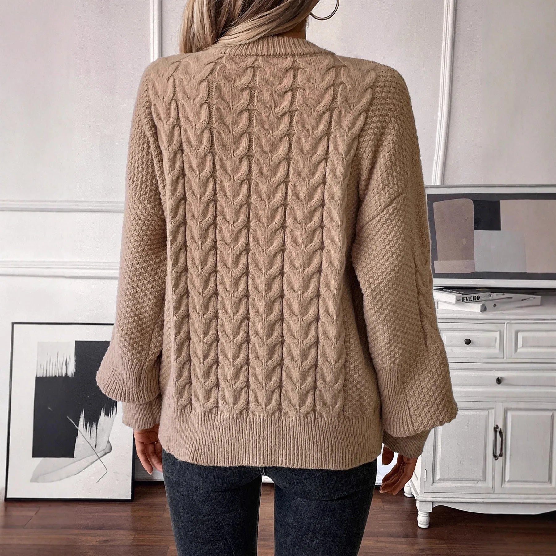 Women's loose beige round neck casual sweater with textured thread detail on a hanger.