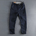 Men's khaki cotton trousers with belt buckle detail on mid waistband