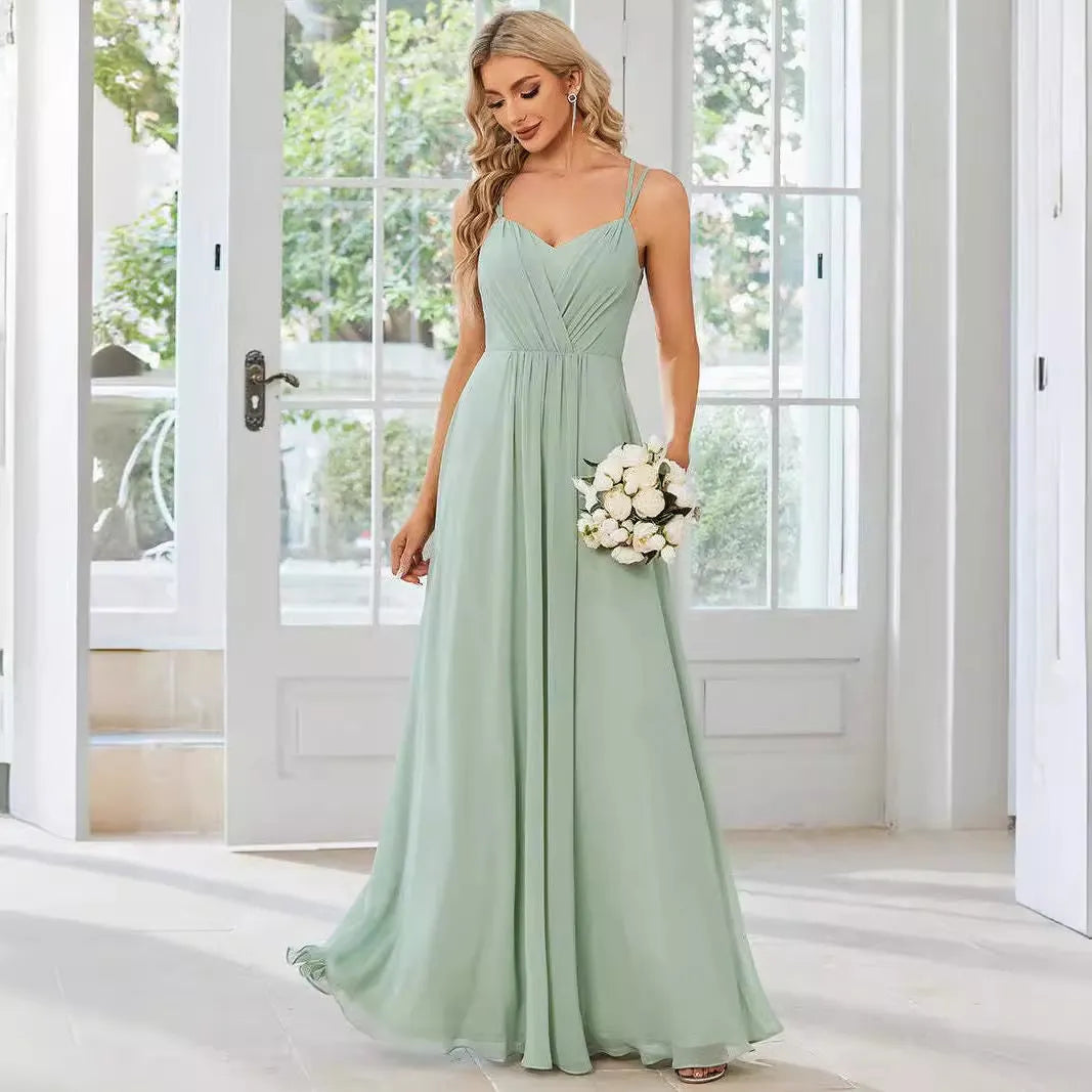 A sleeveless light green women's dress with a pleated A-line long skirt on a mannequin.