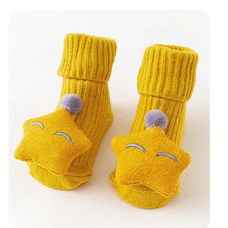 Cotton baby floor socks in various designs including blue bow and lion, showing sizes for infants 0-3 months