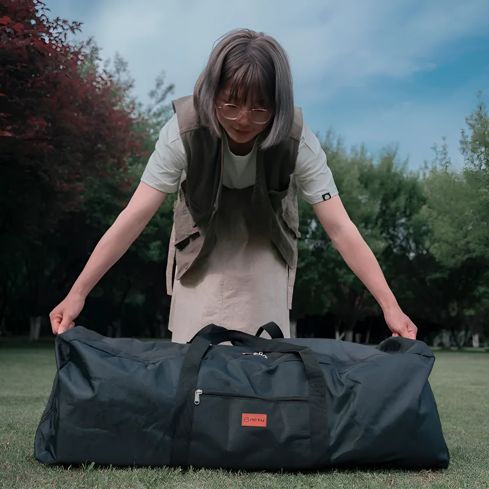 Waterproof camping equipment storage bag in 100L and 150L capacities with folding table and chair