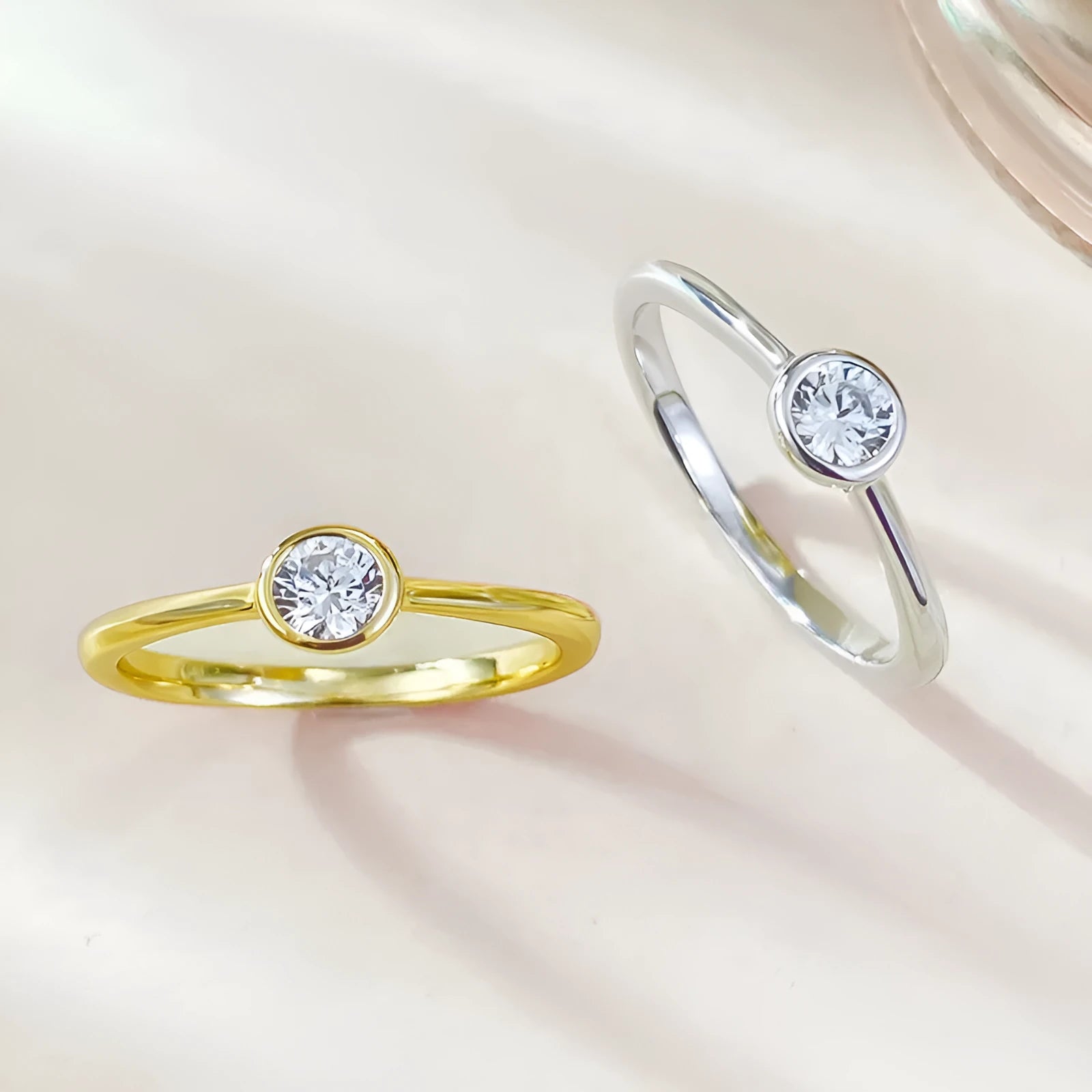 Minimalist silver crown-shaped ring with linear details, shown in gold and platinum finishes.