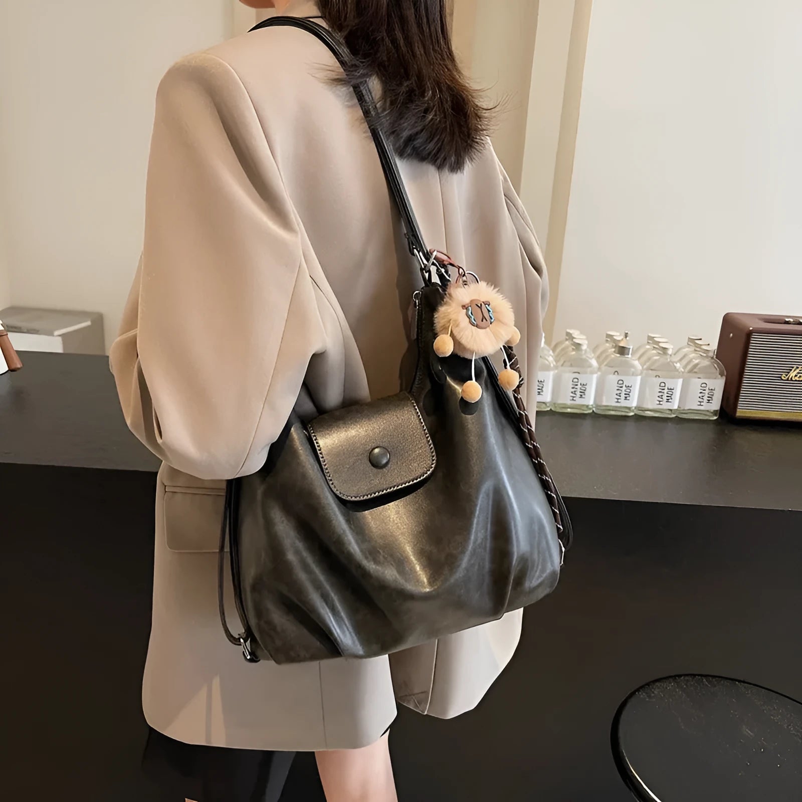 Women's black PU leather single shoulder bag with horizontal square shape and optional pendant attachment