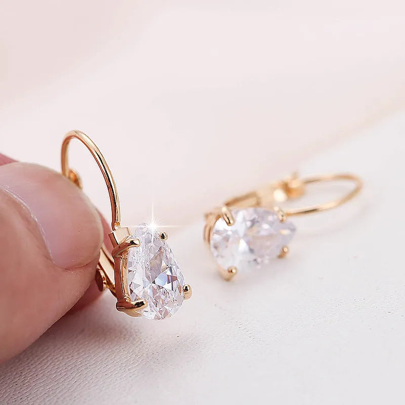Women's drop-shaped copper earrings with a gemstone inlay, available in gold or platinum colour finish.