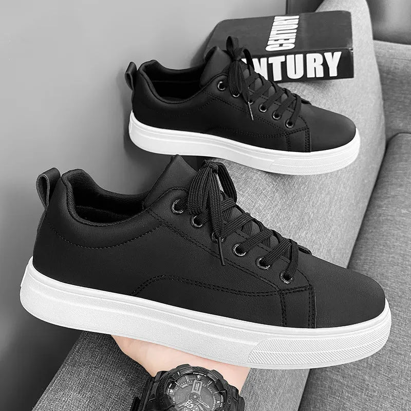 Men's low-top Korean-style sneakers in white, black, or black and white with a round toe and rubber sole.