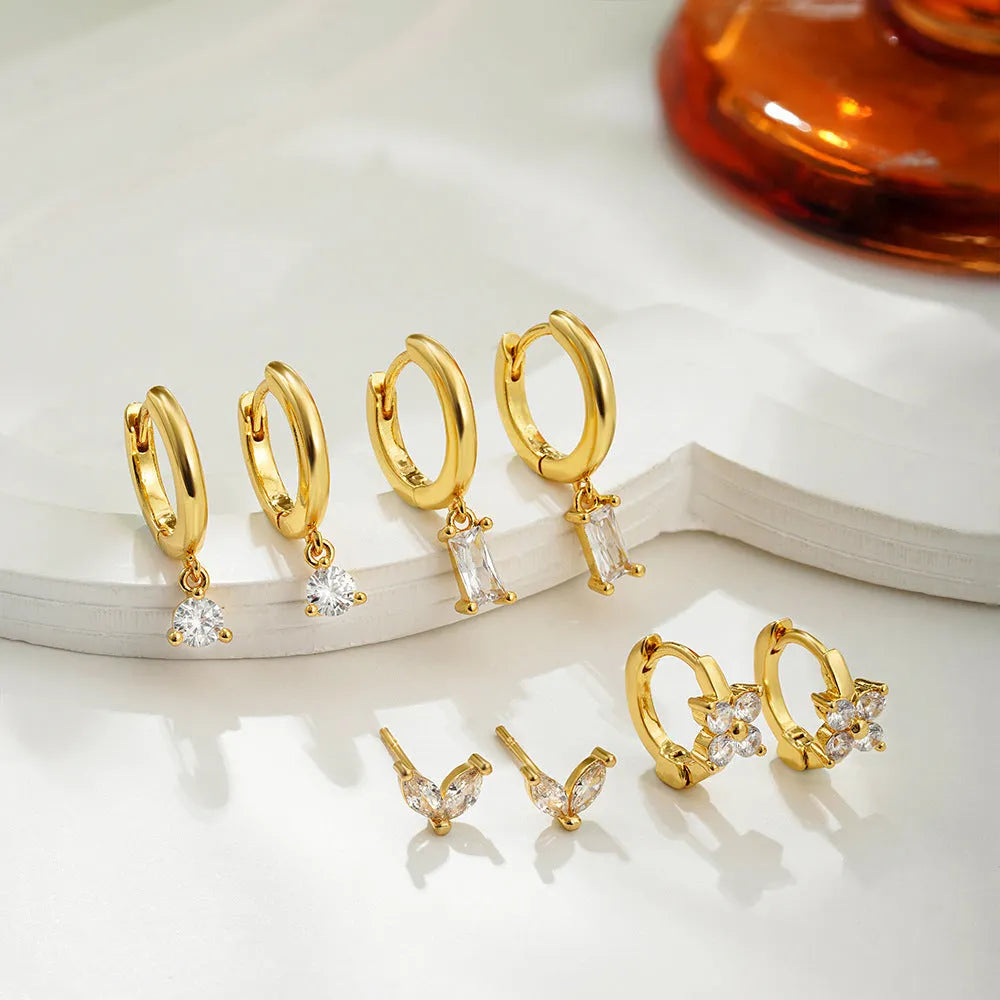 Geometric copper earrings with electroplated gold finish featuring star shapes and zircon detailing