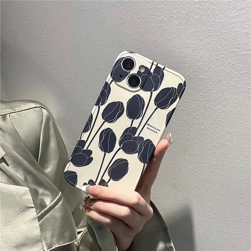 Black silicone iPhone case with tulip flower design shown on mobile phone