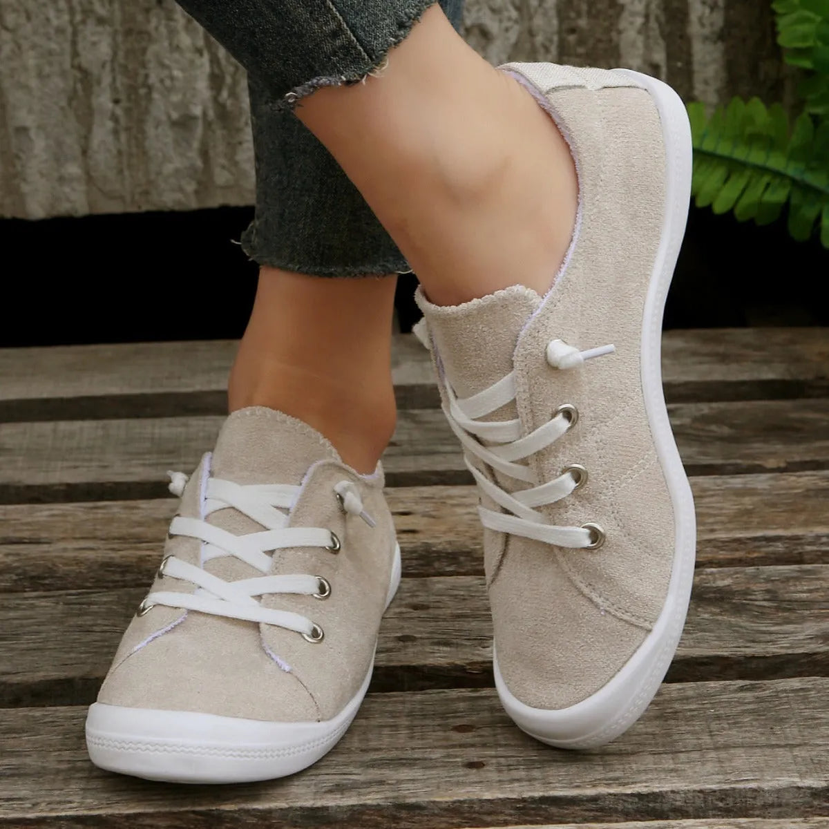 Creamy-white women's low-top fabric casual sneakers with a rubber sole.
