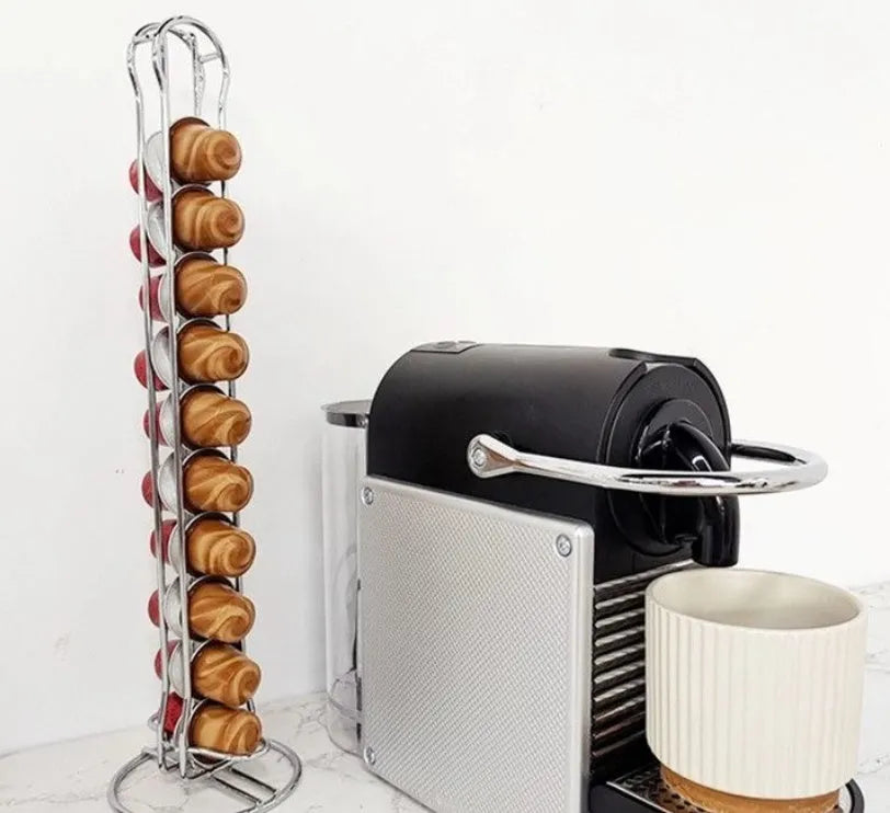 Black wrought iron coffee capsule storage rack holding pods on display shelves.