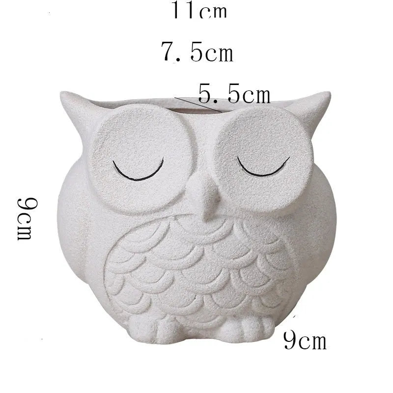 Handmade frosted ceramic owl planter for small succulents, shown in light pink.