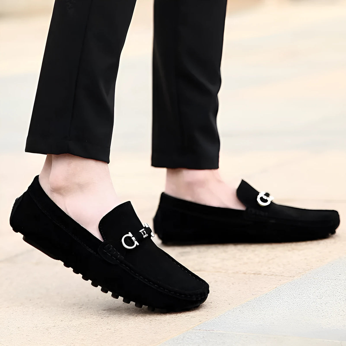 Men's black matte cowhide leather slip-on loafers with a square toe and flat rubber sole.