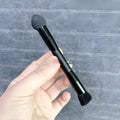 Black sponge tip concealer brush with wooden handle for makeup application.
