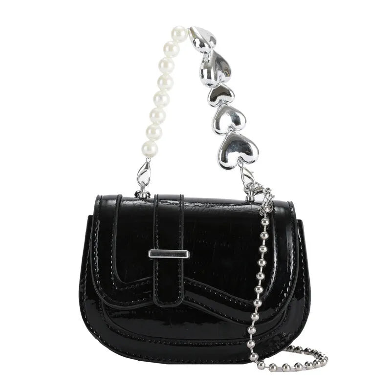 Women's silver PU crossbody bag showing horizontal square tote saddle shape and single shoulder strap