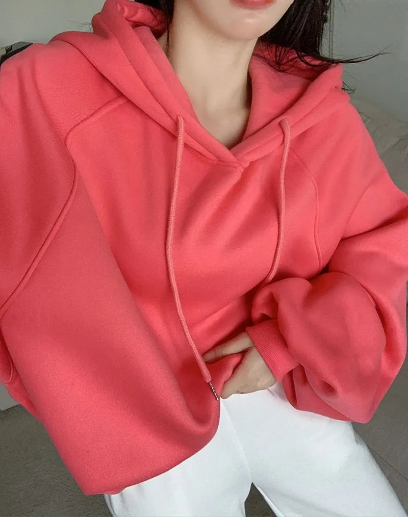 Women's loose watermelon red hooded sweater made from Mulberry Silk, shown on a hanger.