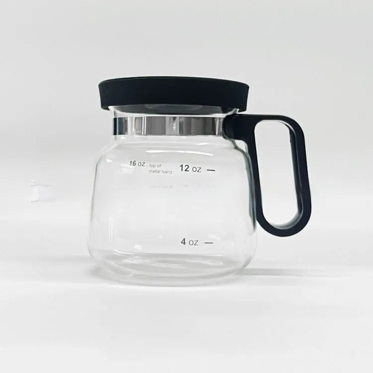 Transparent borosilicate glass coffee maker with a black silicone cover on its lid.