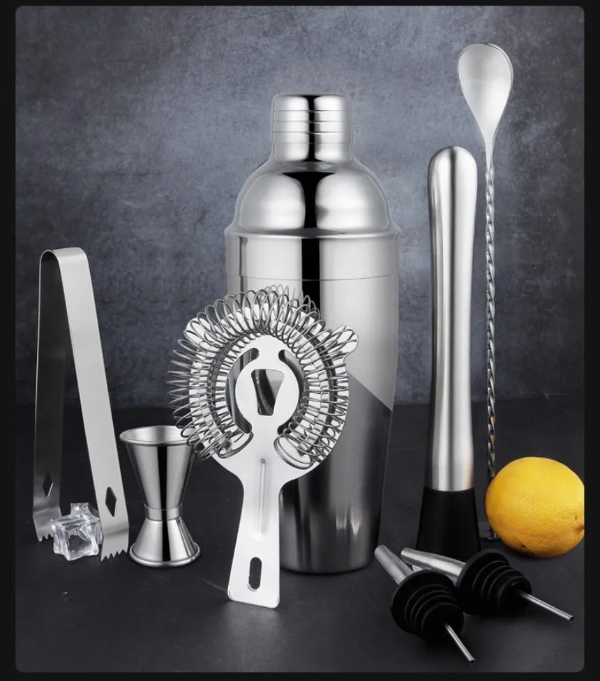 23-piece stainless steel cocktail bar set with acrylic European style mixers laid out on a table.