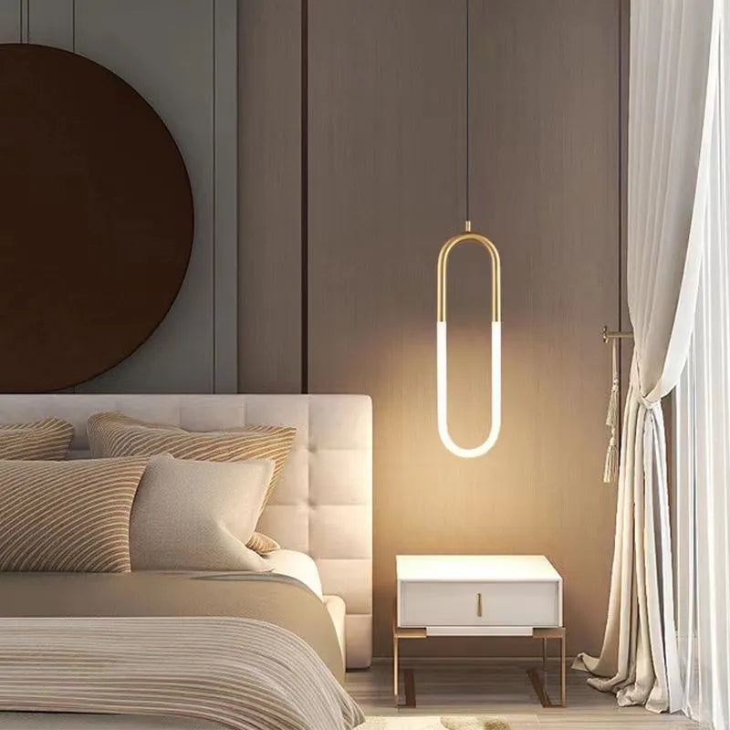 Nordic minimalist U-shaped metal bedside pendant light on a dark background.