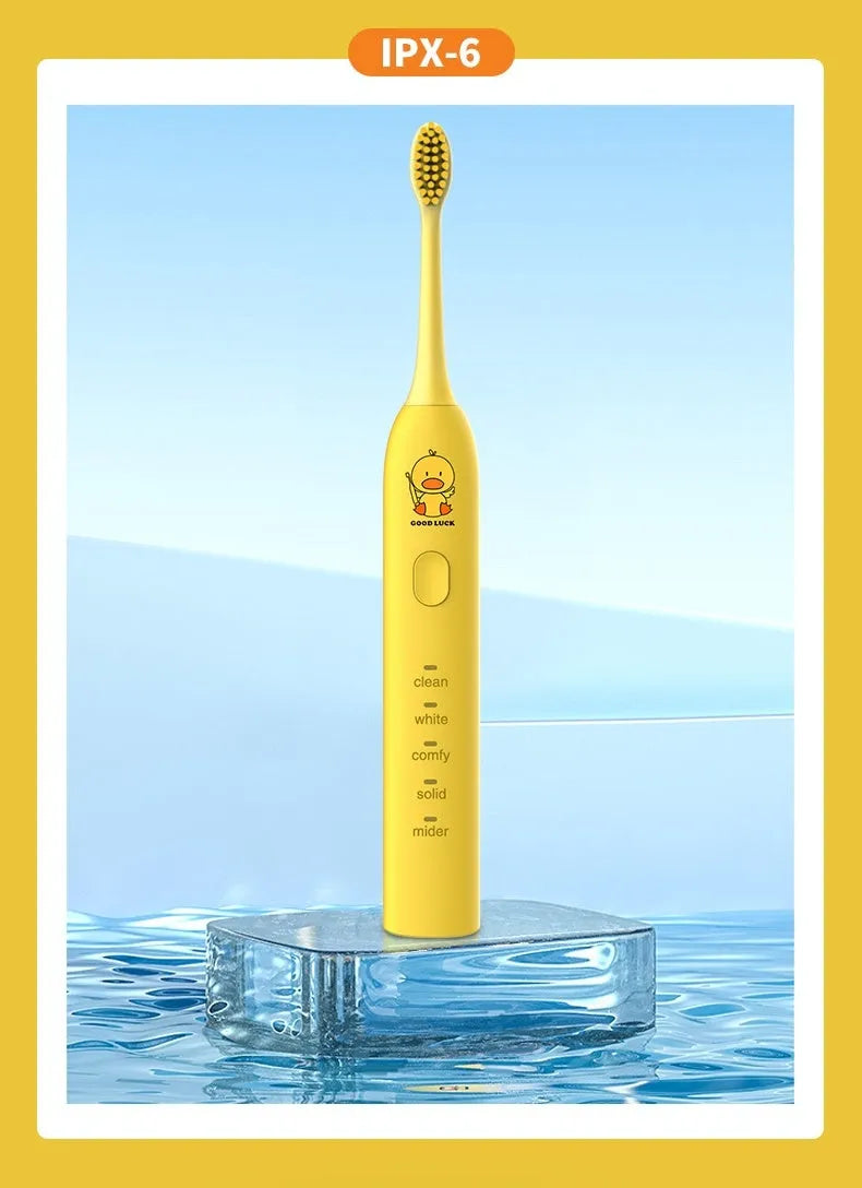 Yellow duck design USB rechargeable electric toothbrush with soft bristles on a bathroom counter.