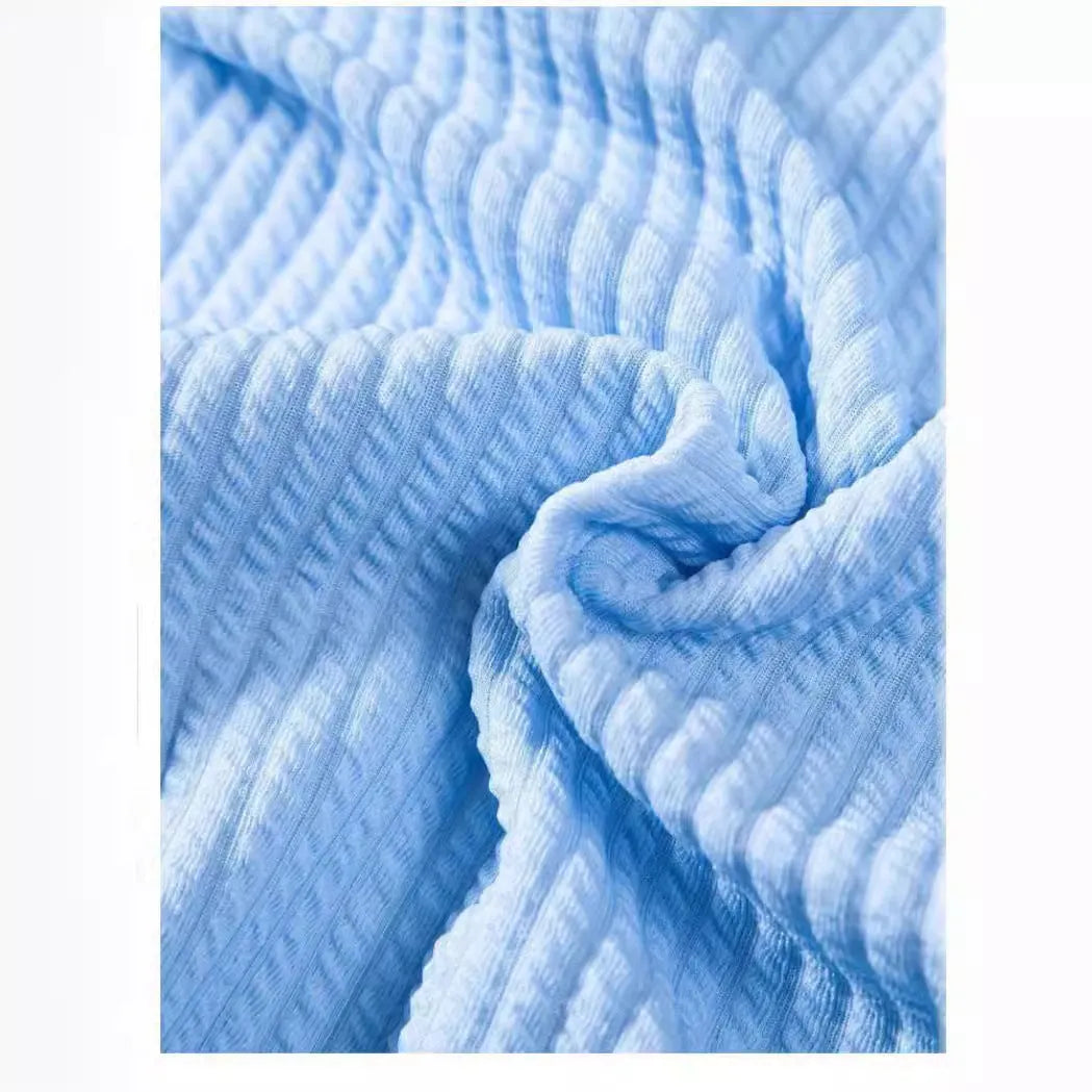 Man wearing a loose-fitting short sleeve polyester shirt in light blue, showcasing the casual summer style.