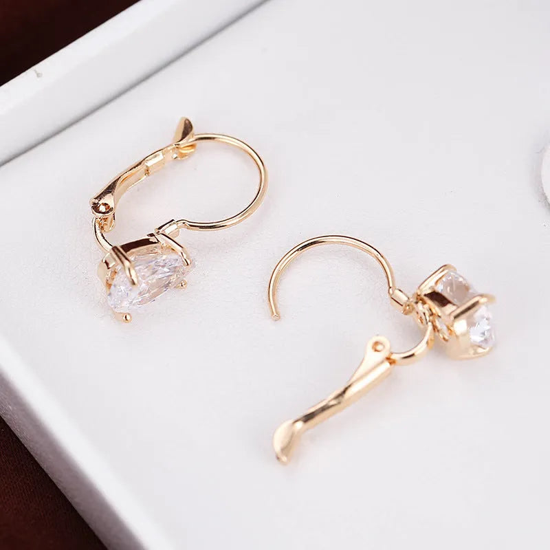 Women's drop-shaped copper earrings with a gemstone inlay, available in gold or platinum colour finish.