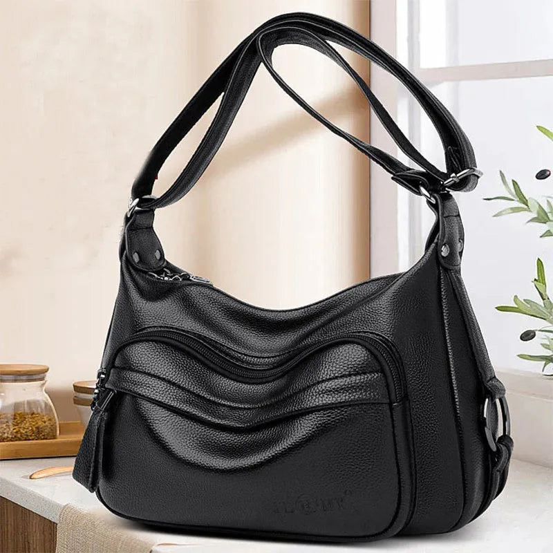 Large blue women's shoulder bag with multiple internal compartments and crossbody strap