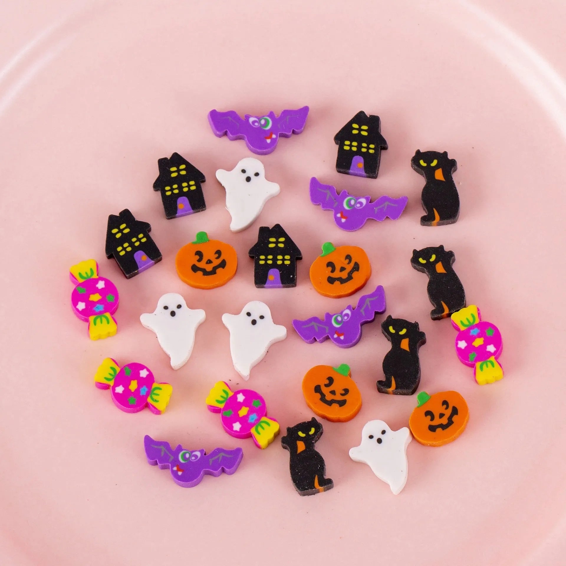 Open pearlescent film bag showing 50 small colourful cartoon fruit-themed rubber erasers.