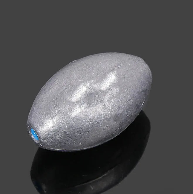 Olive-shaped fishing sinker with scale texture and plastic core construction for sea fishing