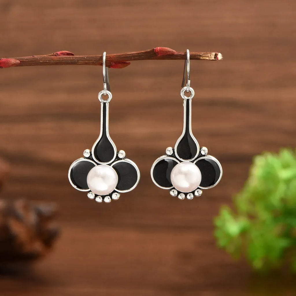 Pair of silver retro-style creative alloy earrings for women on a white background.