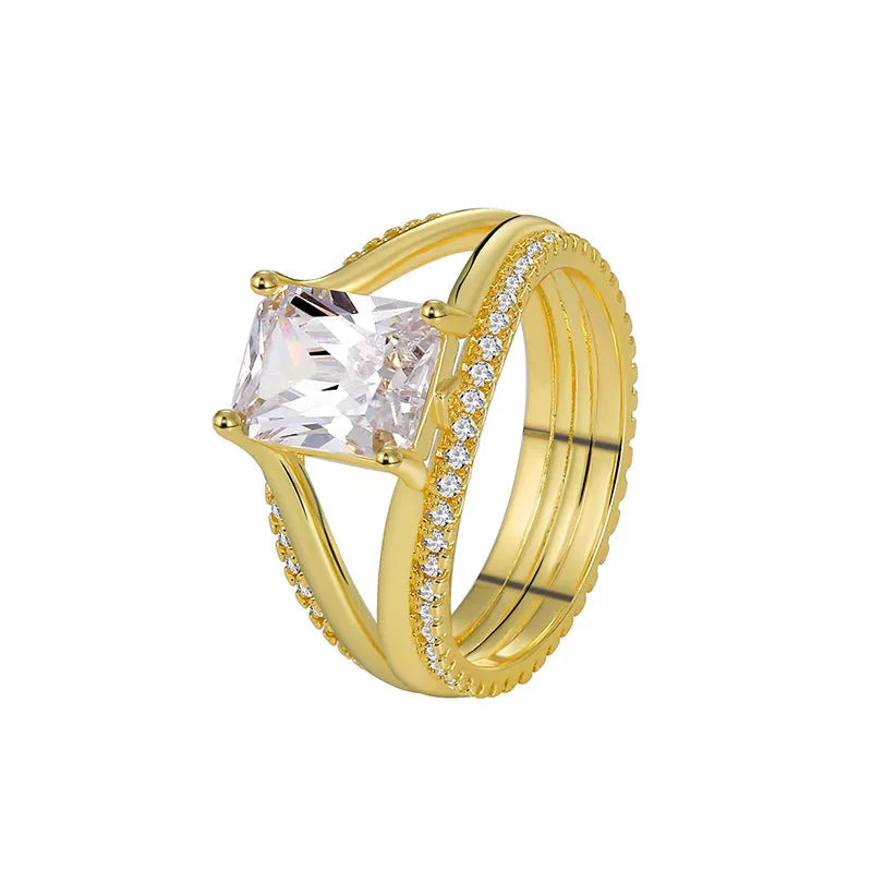 Gold geometric women's ring with a square zircon stone on a copper band.