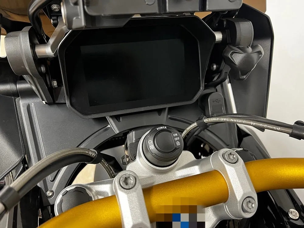 Black motorcycle cockpit fairing for BMW R1250GS and R1200GS models mounted on adventure bike