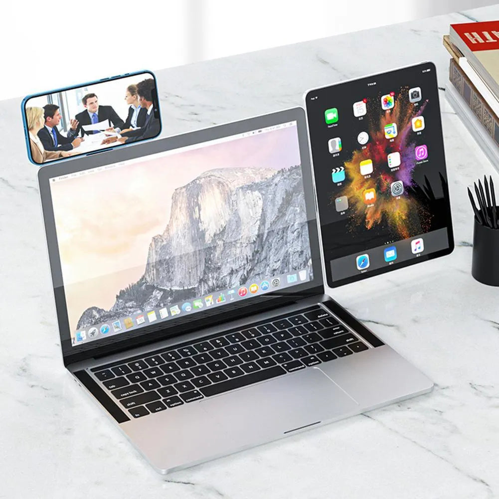 Black aluminium laptop phone holder with magnetic mount attached to laptop edge