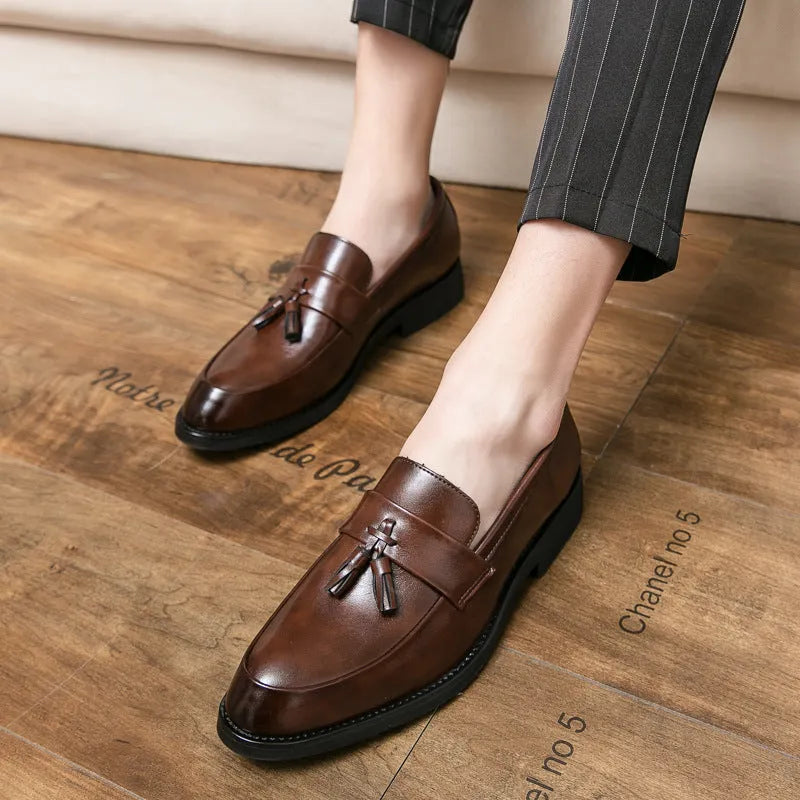 Men's black slip-on business casual shoes with tassel detail and rubber sole