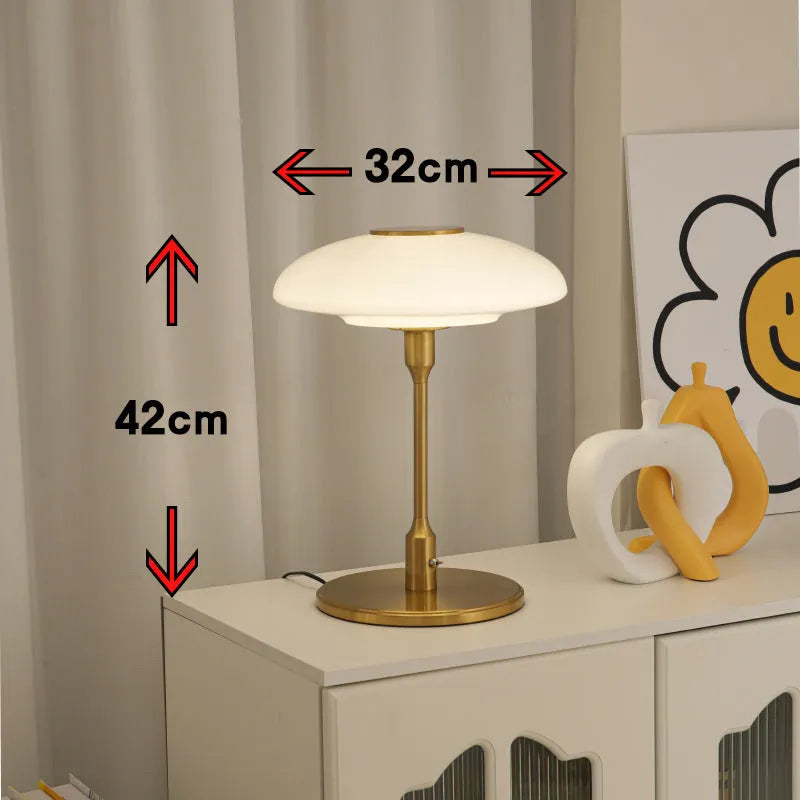 Korean style golden orange atmosphere light with metal base on a bedside table.