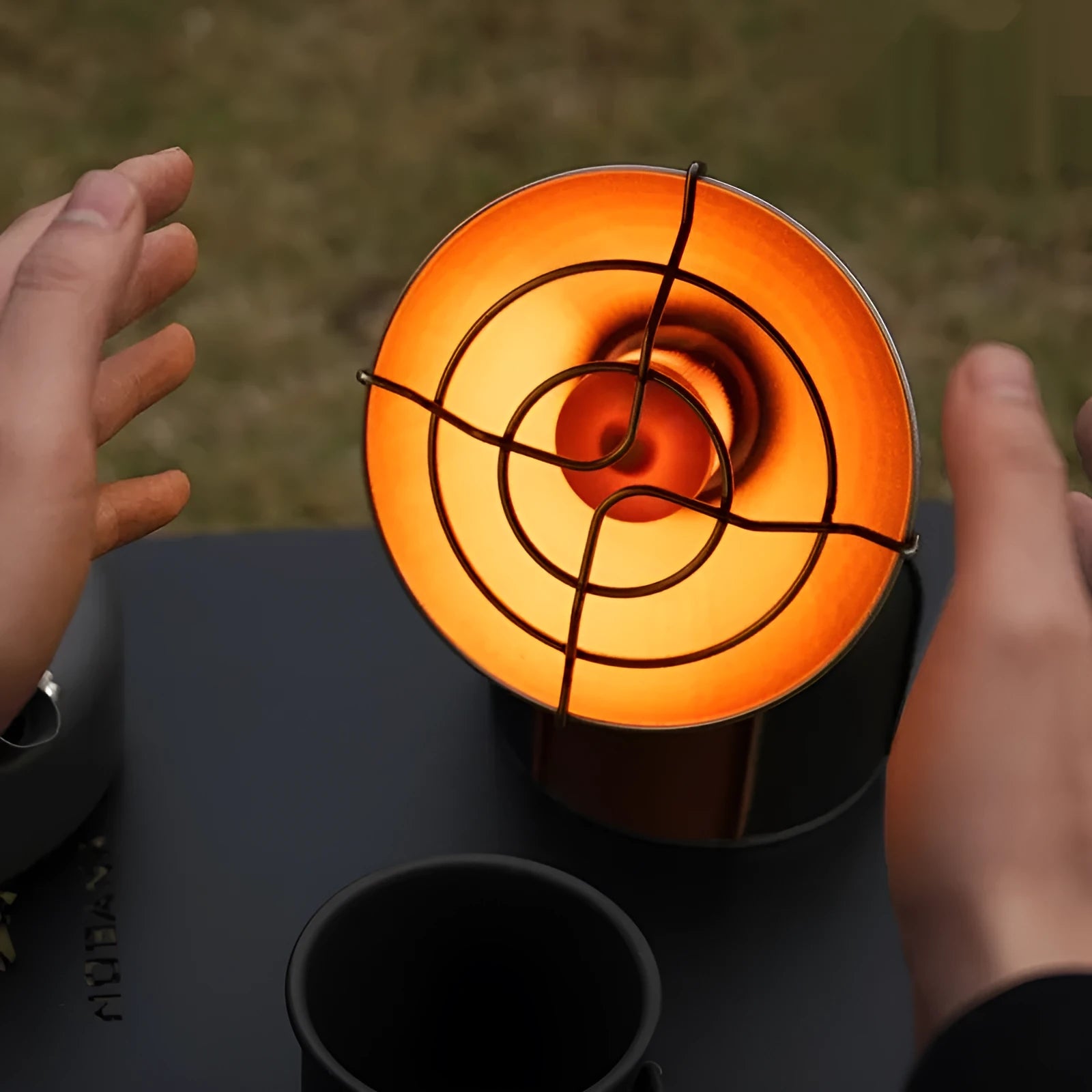 Portable black and orange camping heating stove with automatic ignition